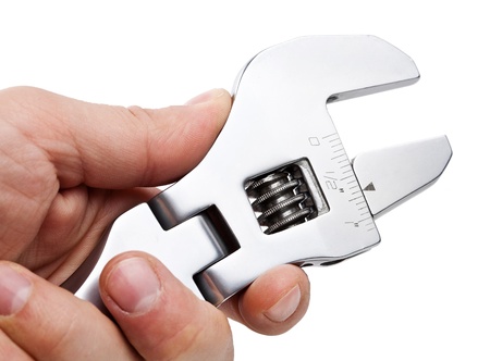 Wrench in the man's hand, isolated on whiteの写真素材