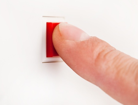 Finger pushing a red button 