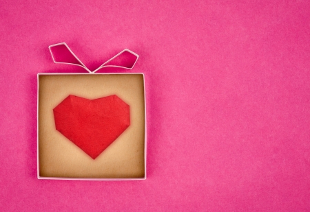Hand made gift box with heart inside, textured  paper as background. Greeting card の写真素材