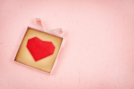 Hand made gift box with heart inside, textured  paper as background. Greeting card の写真素材