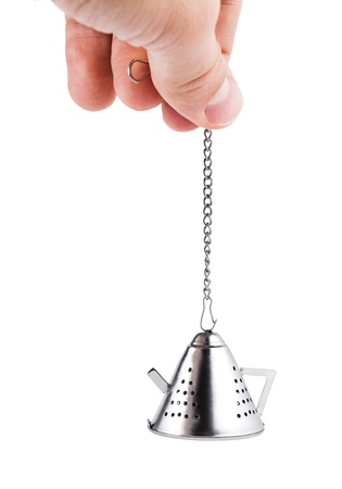 Hand holding Tea strainer, isolated on whiteの写真素材