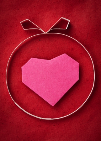 Hand made paper heart on red kraft paper as background. Greeting cardの写真素材