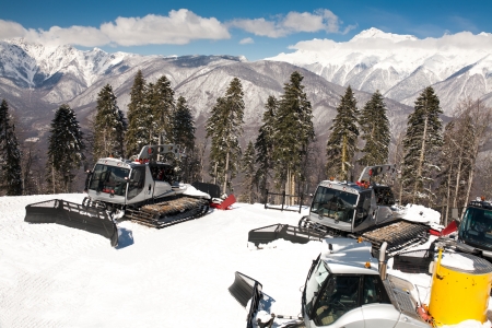 Snowplows, montains on backgroundの写真素材