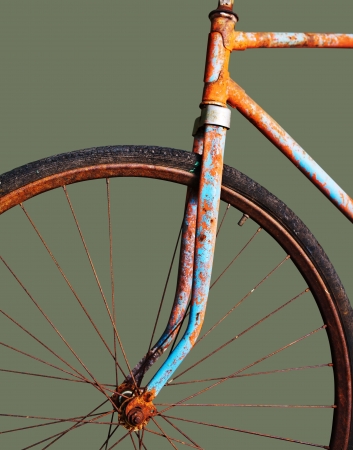 Old rusty bicycle, isolated on greenの写真素材