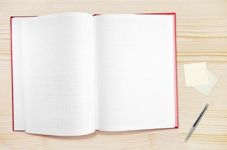 Blank notepad with pen on wood table, free space for textの写真素材