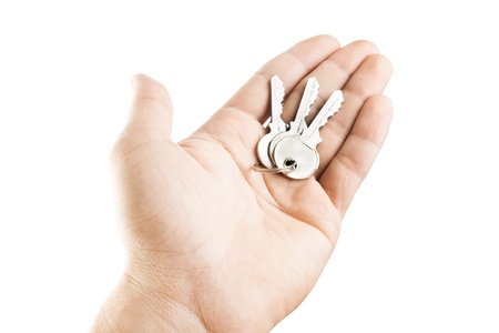 Hand holding keys isolated on white の写真素材
