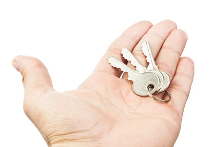 Hand holding keys isolated on white 