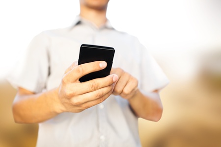 Close up of a man using mobile smart phoneの写真素材