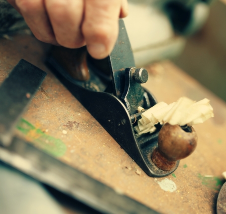 Old carpenter working with woodの写真素材