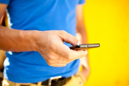 Young man using mobile smart phone, summer outdoor の写真素材