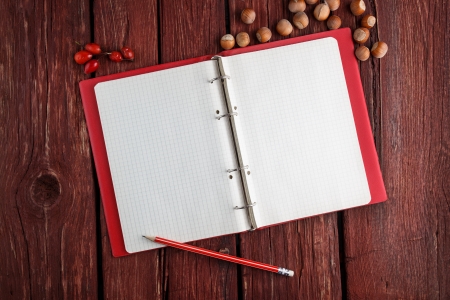 Open blank notepad  with a pencil laying on old wooden table の写真素材