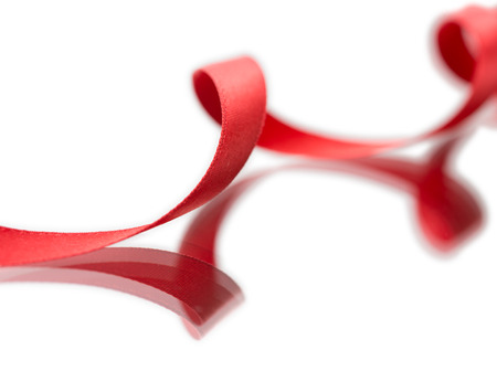 Beautiful fabric red ribbon on white background の写真素材