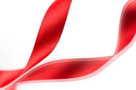 Beautiful fabric red ribbon on white background の写真素材