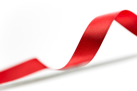 Beautiful fabric red ribbon on white background の写真素材