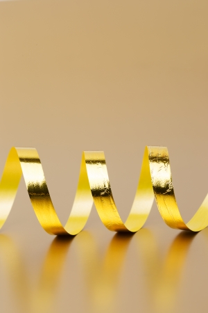 Golden ribbon on golden backgroundの写真素材