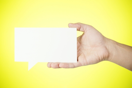 Man holding blank paper speech bubble の写真素材