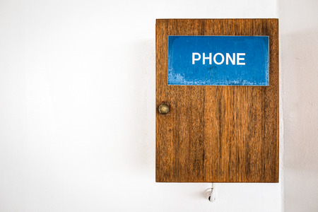 Public telephone on white wallの写真素材