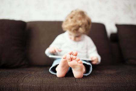 Little boy using tablet computer, indoor の写真素材