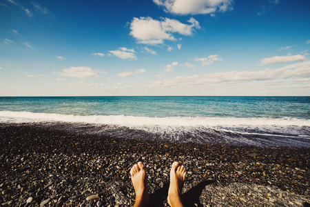 Photo of male legs over beach background, wide angleの写真素材