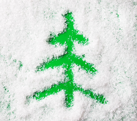 Christmas tree shape on snow backgroundの写真素材