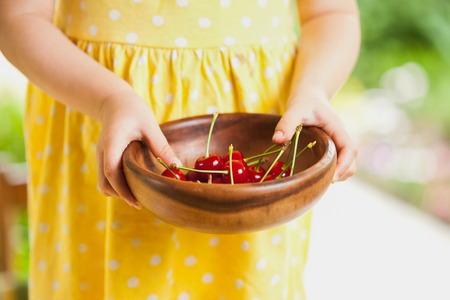 Cherry in wooden bowlの写真素材