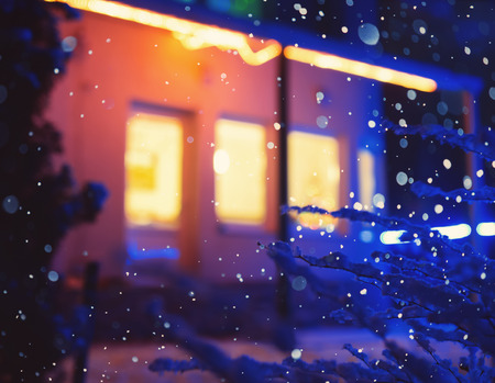 Illuminated windows at night. Winter, snowfall. Defocused  backgroundの写真素材