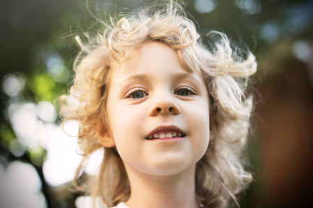 Cute little girl portrait in summer day, shallow dofの写真素材