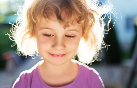 Adorable little girl taken closeup outdoors in summerの写真素材
