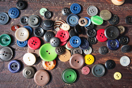 Set of vintage buttons on old wooden table