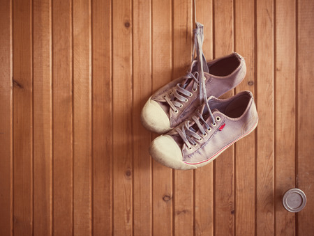 Old worn sneakers on woodの写真素材