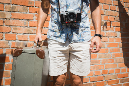 Tourist  staying  the street, carrying suitcase. Travel conceptの写真素材