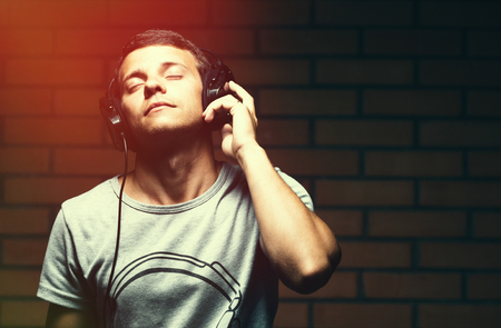 Portrait of a handsome young man listening to musicの写真素材