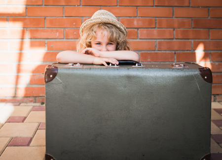 Little girl with vintage suitcase. Travel conceptの写真素材