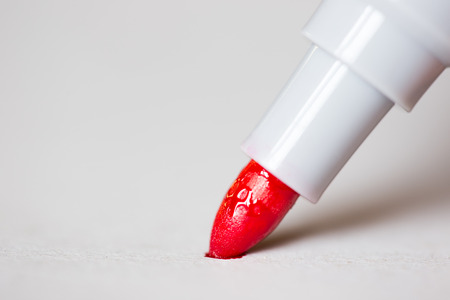 Red marker draws a line close up photo