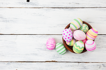Easter eggs painted in pastel colors on white wooden background. Easter conceptの写真素材