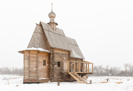 Wooden old church in Russia at winterの写真素材