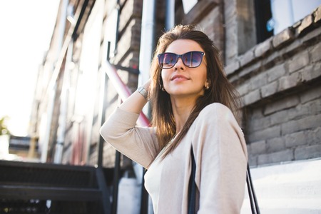 Young pretty woman outdoor fashion portrait. Beautiful girl casual dress and sunglasses.の写真素材