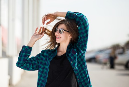 Portrait of urban fashionable girl posing outdoors in the city.の写真素材