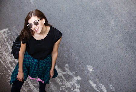 Brunette girl in rock black style, standing outdoors in the city.の写真素材