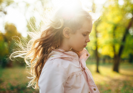 Autumn portrait of cute blonde girl.の写真素材