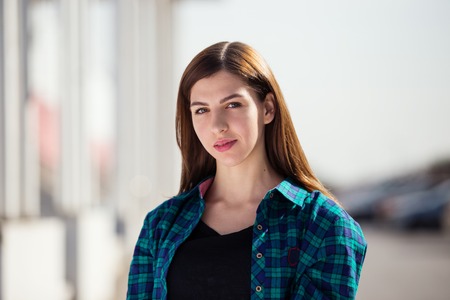 Urban fashionable girl posing outdoors in the city.の写真素材