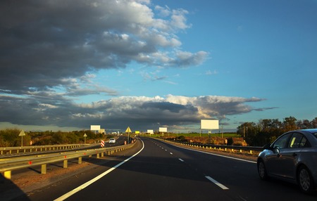 Two way highway traffic in sunset with cars