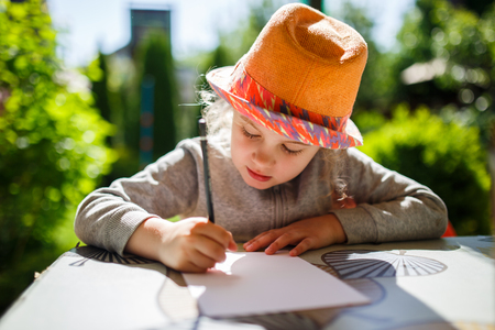 Cute little girl in straw hat, spring outdoor.の写真素材