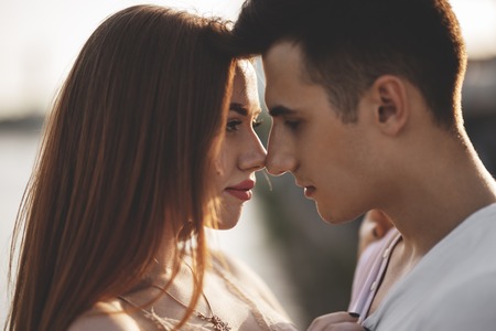 Portrait of young couple in love, enjoying the sunset in cityの写真素材