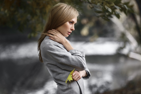 Fashion portrait of beautiful blonde woman in stylish clothes outdoor in autumn.の写真素材
