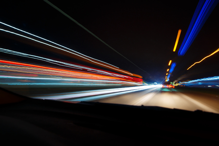 Night driving.Long exposure photo.City colorful night lights perspective blurred by high speed of the car.の写真素材