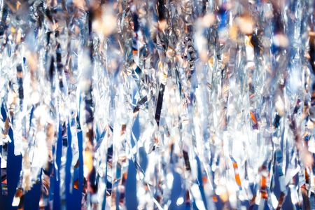 Silver serpentine shiny glitter background. Christmas and new year holiday concept.の写真素材