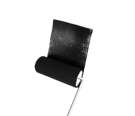 Painting wall in black with a paint rollerの写真素材