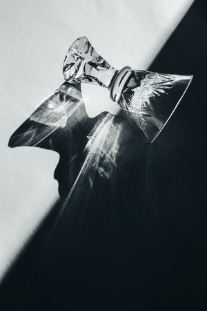 Glass goblets cast beautiful shadow and beautiful caustic effect as light passes through a glass in...