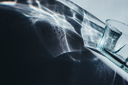 Glass goblets cast beautiful shadow and beautiful caustic effect as light passes through a glass in early morningの写真素材